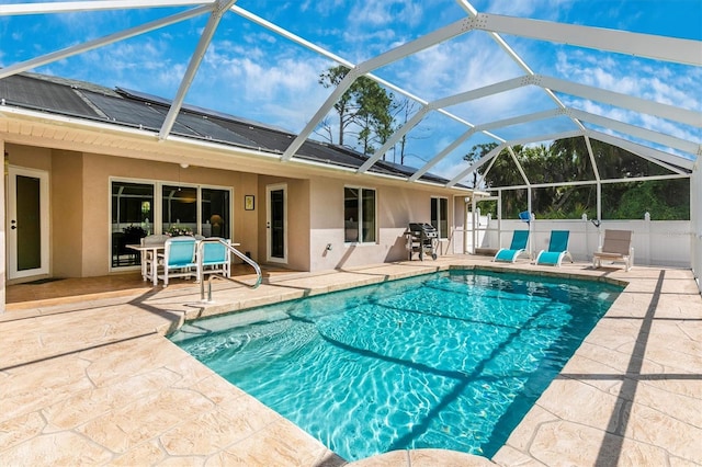 view of swimming pool with a grill, a lanai, and a patio area