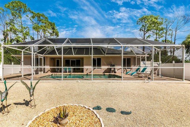 rear view of house featuring a fenced in pool, a patio, and a lanai