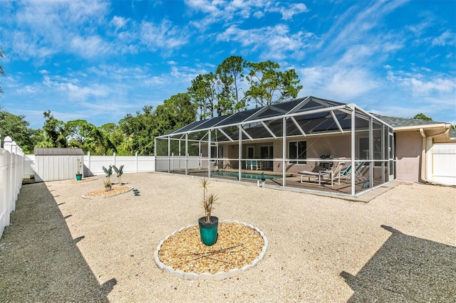 back of property with a lanai, a storage unit, and a patio area