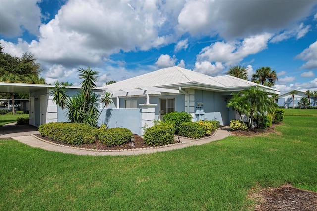 view of side of property with a carport and a yard