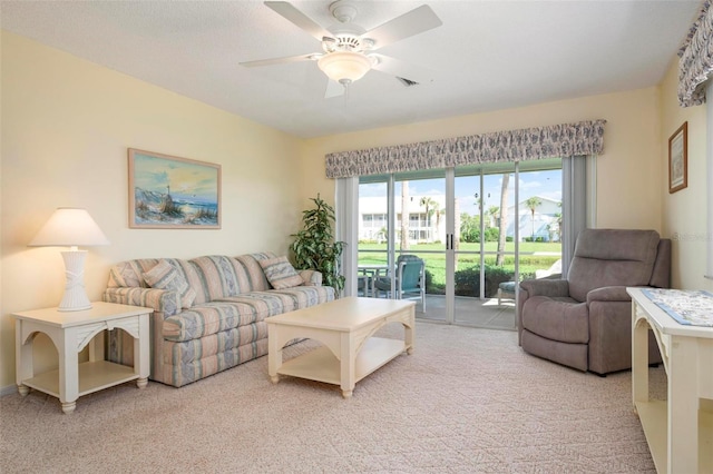 living room with ceiling fan and light colored carpet