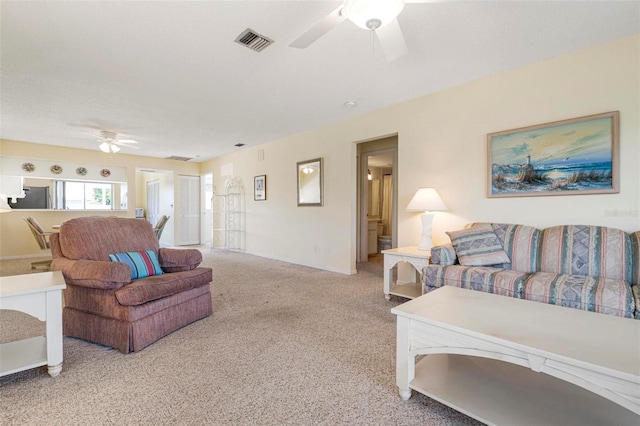 carpeted living room featuring ceiling fan