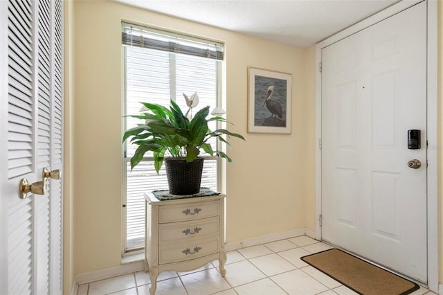 entrance foyer featuring a textured ceiling and light tile patterned flooring