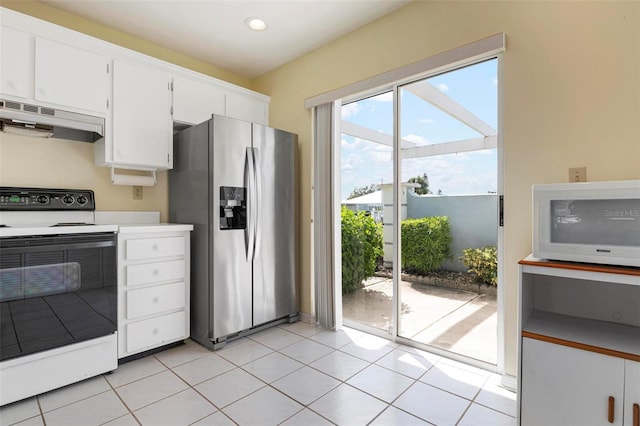 kitchen featuring light tile patterned floors, white cabinetry, white appliances, and range hood