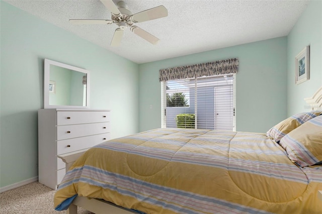 bedroom featuring ceiling fan, a textured ceiling, and carpet