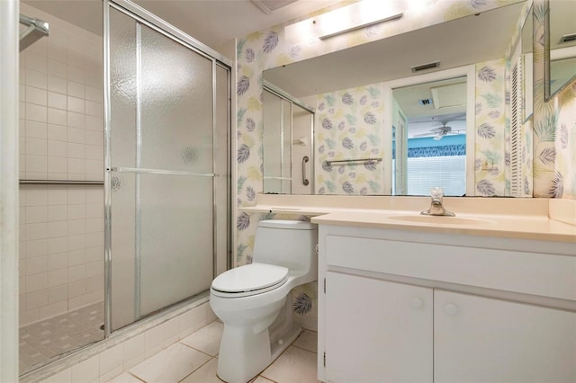 bathroom featuring vanity, a shower with shower door, toilet, and tile patterned flooring