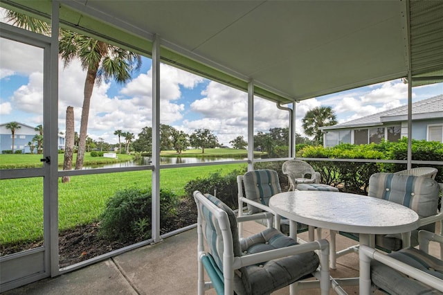 sunroom / solarium featuring a wealth of natural light and a water view