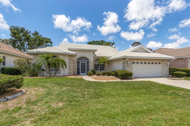 mediterranean / spanish-style house with a garage and a front yard