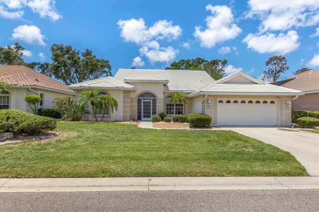 view of front facade with a garage and a front lawn