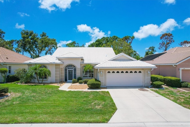 view of front of home featuring a front yard and a garage