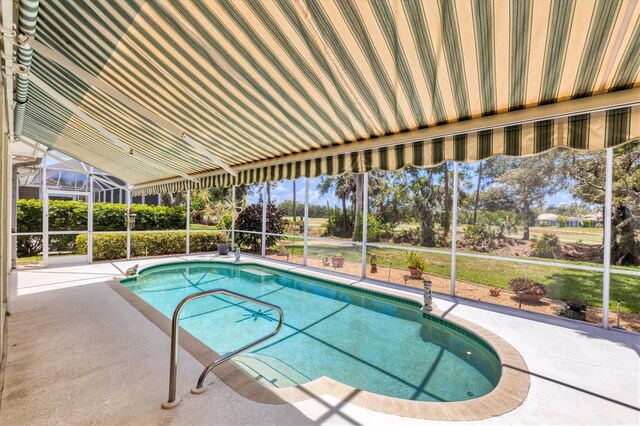 view of swimming pool with glass enclosure and a patio