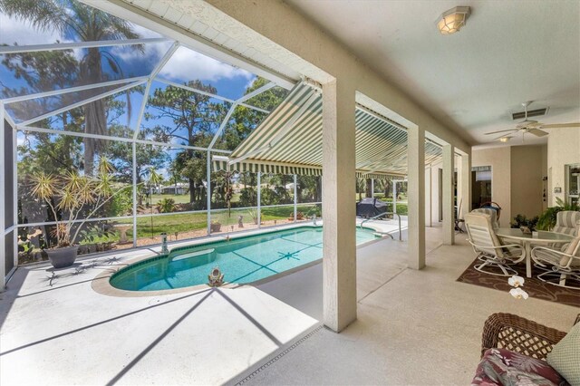 view of pool with a patio, a lanai, and ceiling fan