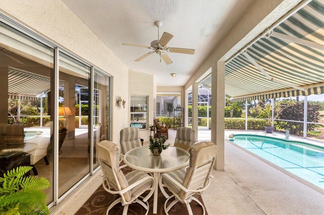 view of pool featuring a lanai, ceiling fan, and a patio area