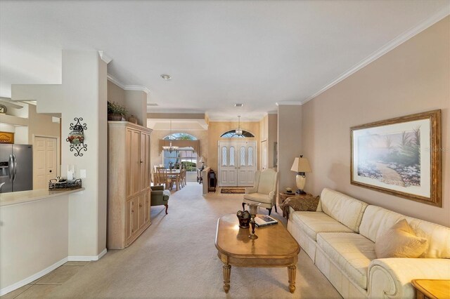 living room with an inviting chandelier, light carpet, and crown molding