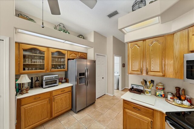 kitchen featuring white appliances, ceiling fan, washer / clothes dryer, and light tile patterned floors