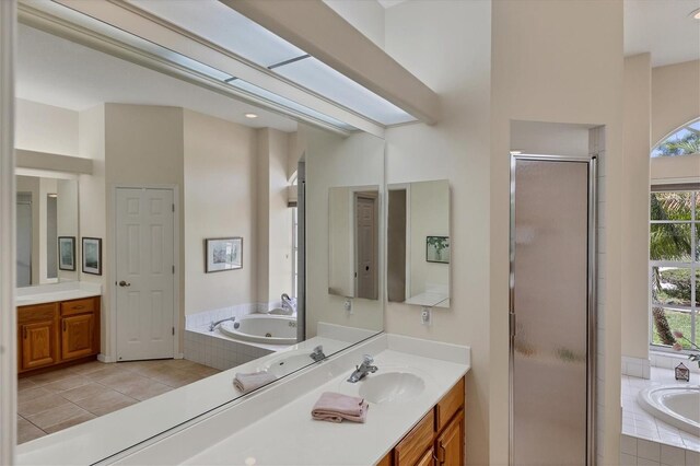 bathroom featuring tile patterned flooring, independent shower and bath, and vanity