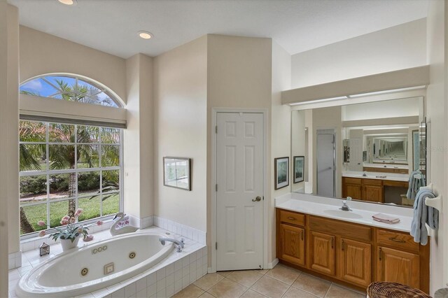 bathroom with independent shower and bath, vanity, and tile patterned floors