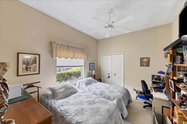 carpeted bedroom featuring ceiling fan and a closet