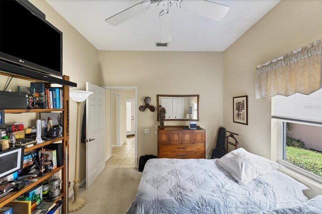 bedroom featuring ceiling fan and light carpet