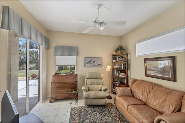 tiled living room featuring ceiling fan