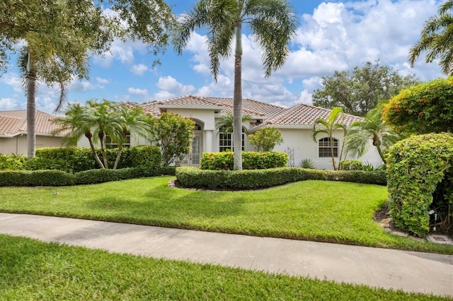 mediterranean / spanish-style house featuring a front lawn