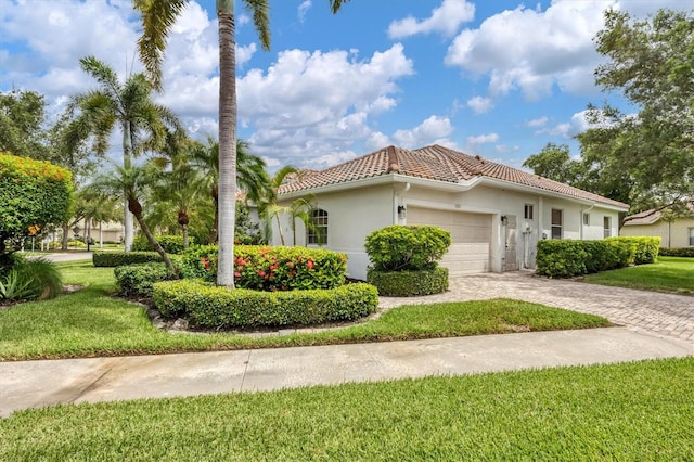 view of front of property with a front lawn and a garage