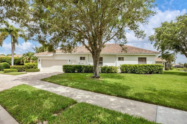 view of front of property with a front yard and a garage