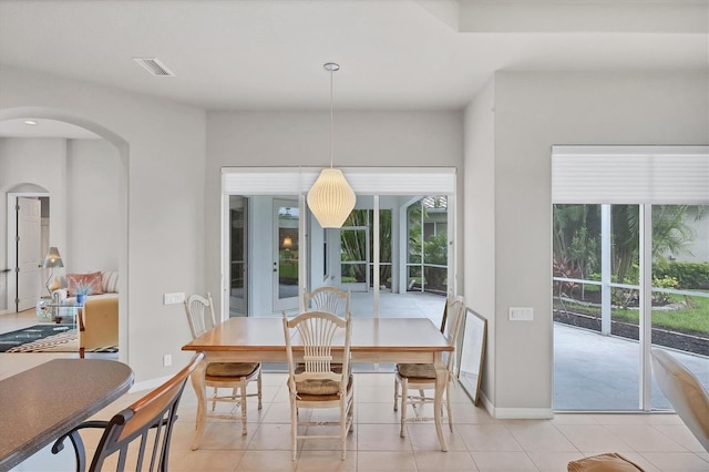 dining area featuring light tile patterned floors and a healthy amount of sunlight