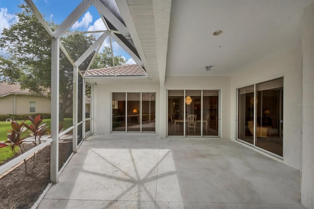 unfurnished sunroom with vaulted ceiling with beams