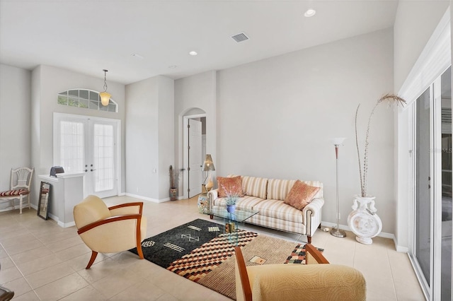 living room with french doors and light tile patterned flooring