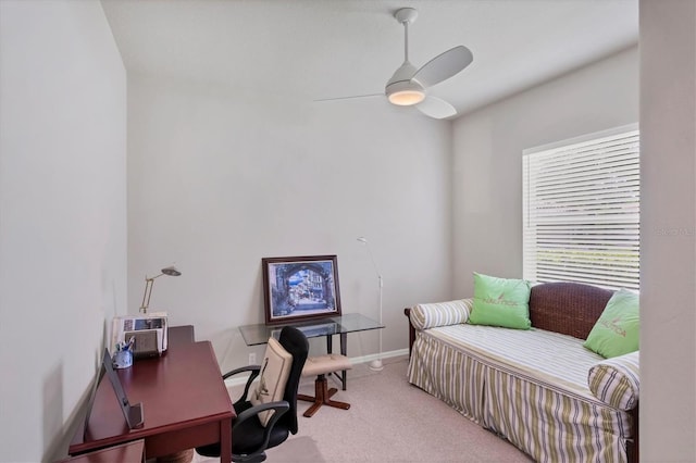 carpeted office space with ceiling fan