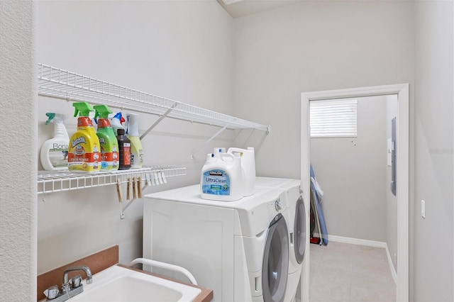 washroom with sink and washing machine and dryer