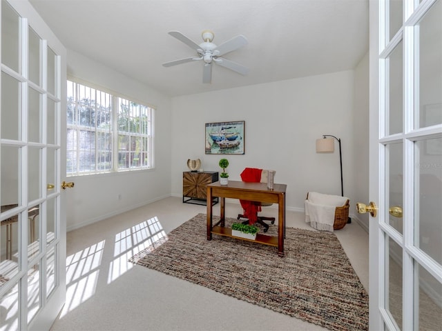 office featuring ceiling fan, light carpet, and french doors