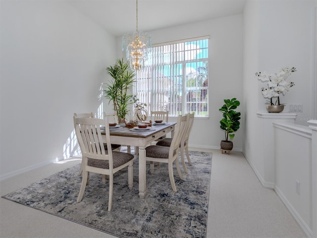 dining room featuring carpet floors and an inviting chandelier