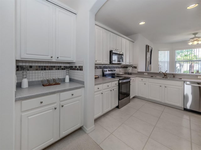 kitchen featuring decorative backsplash, sink, white cabinetry, and stainless steel appliances