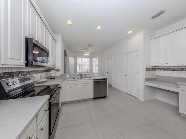 kitchen with backsplash, stainless steel appliances, ceiling fan, sink, and white cabinetry