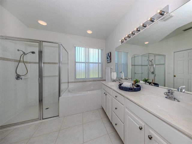 bathroom featuring shower with separate bathtub, vanity, and tile patterned floors