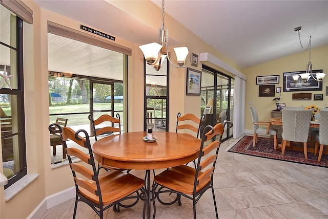 tiled dining space with an inviting chandelier and vaulted ceiling