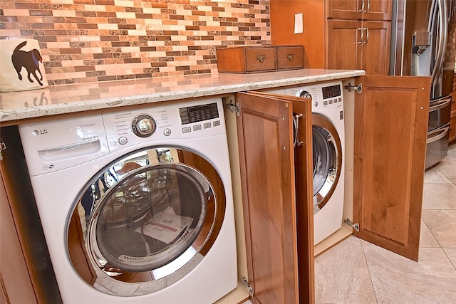 clothes washing area featuring washer / clothes dryer and light tile patterned flooring