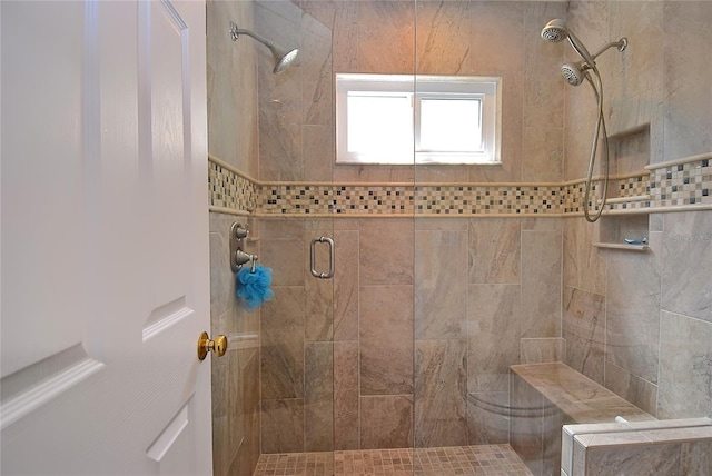 bathroom with a shower with door