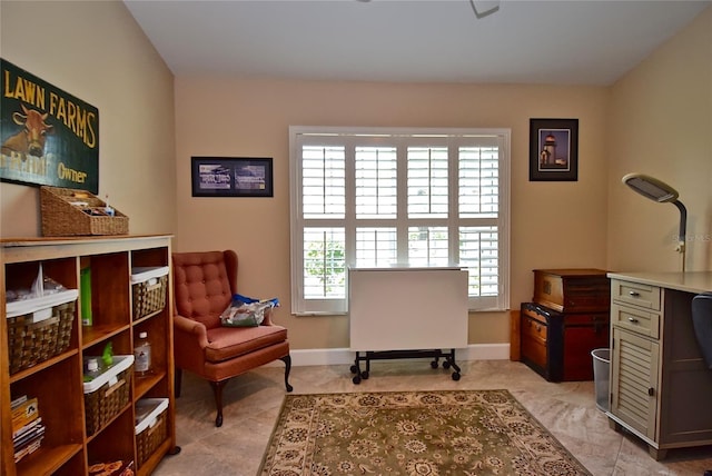 sitting room with a healthy amount of sunlight and light tile patterned floors