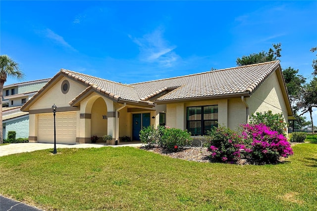 217 Carriage House Ln Unit 217, Nokomis, FL 34275 - view of front facade with stucco siding, an attached garage, a front yard, and a tiled roof