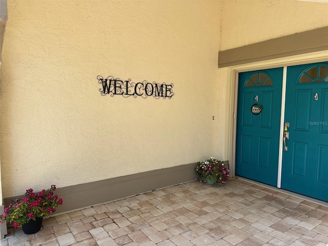 217 Carriage House Ln Unit 217, Nokomis, FL 34275 - view of exterior entry with stucco siding