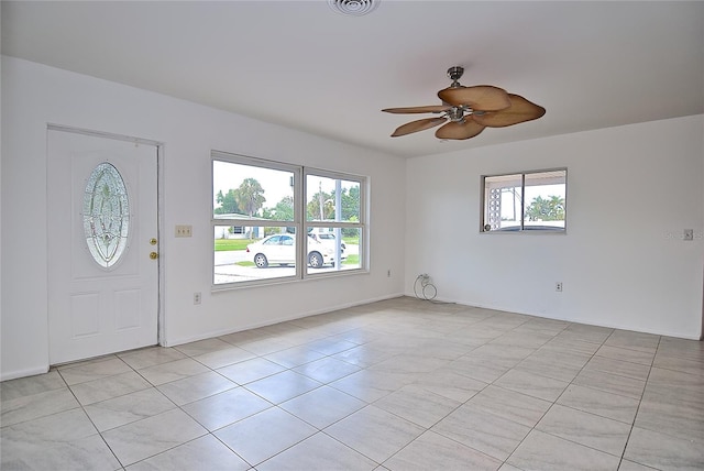 foyer with ceiling fan and a wealth of natural light