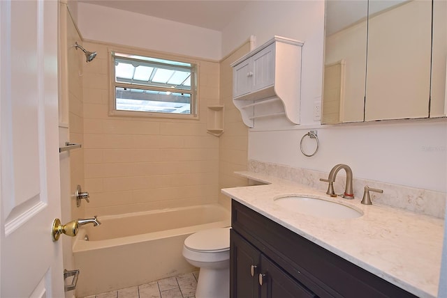 full bathroom featuring vanity, tiled shower / bath combo, toilet, and tile patterned flooring