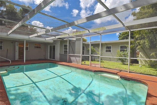 view of pool featuring glass enclosure and a patio area