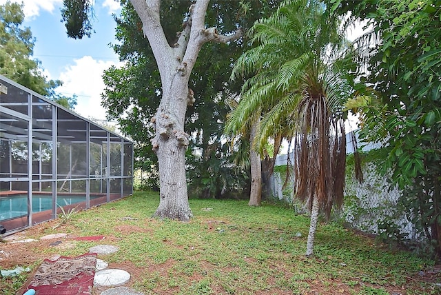 view of yard featuring glass enclosure