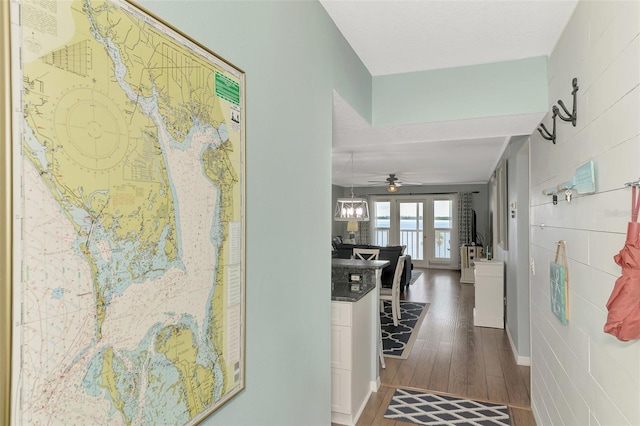 hallway with dark hardwood / wood-style flooring