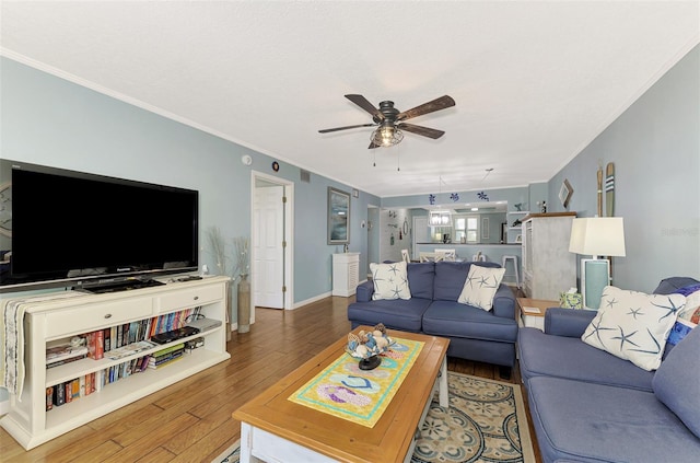 living room with ceiling fan, hardwood / wood-style floors, and crown molding