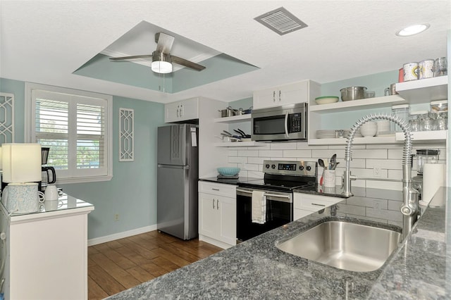 kitchen featuring dark hardwood / wood-style flooring, sink, stainless steel appliances, and white cabinets